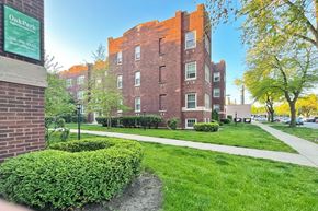 Oak Park apartment for rent - A brick building with a green sign in front of it.