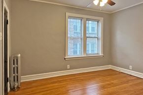 Oak Park apartment for rent - A room with a window and a fan on the ceiling.
