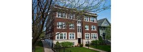 Chicago apartment for rent - a large brick building with a tree in front of it
