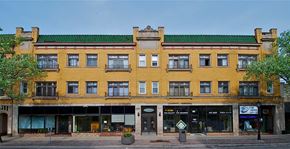 Oak Park apartment for rent - a yellow building with a green roof on a city street