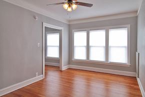 Oak Park apartment for rent - an empty room with wood floors and a ceiling fan