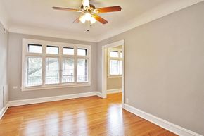 Oak Park apartment for rent - an empty living room with a ceiling fan and wood floors