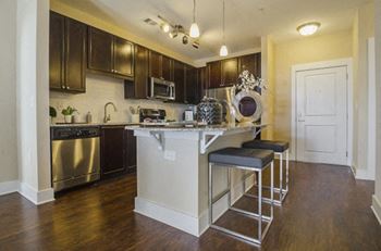 Designer 42-inch espresso cabinets and satin nickel hardware