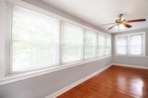 Oak Park apartment for rent - a living room with a large window and a ceiling fan