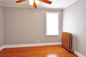 Oak Park apartment for rent - an empty room with a radiator and a ceiling fan