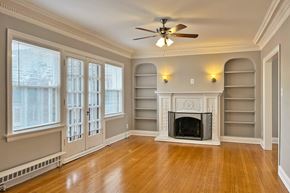 Oak Park apartment for rent - A room with a fireplace and a ceiling fan.