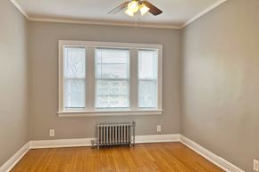 Oak Park apartment for rent - A room with a window and a fan on the ceiling.