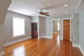 Oak Park apartment for rent - an empty living room with wood floors and a ceiling fan