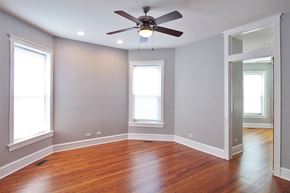 Oak Park apartment for rent - an empty room with wood floors and a ceiling fan