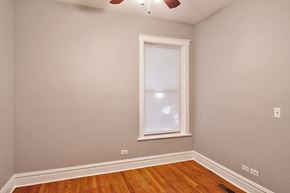 Oak Park apartment for rent - the bedroom of a house with a window and wood floors