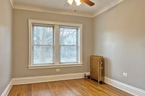 Oak Park apartment for rent - A room with a window and a fan on the ceiling.