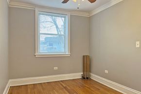 Oak Park apartment for rent - A room with a window and a ceiling fan.