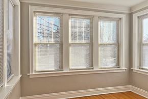 Oak Park apartment for rent - A room with three windows covered in white blinds.