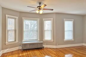 Oak Park apartment for rent - A room with a ceiling fan and three windows.