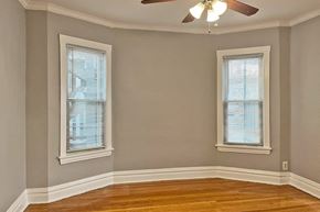 Oak Park apartment for rent - A room with a ceiling fan and two windows.