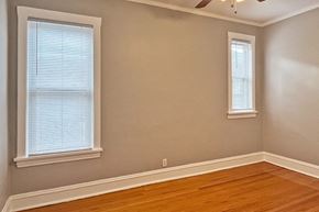 Oak Park apartment for rent - A room with wooden floors and two windows.