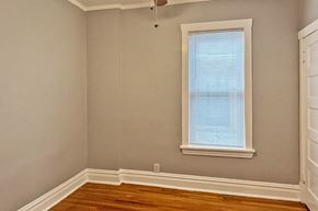 Oak Park apartment for rent - A room with a window and wooden floors.