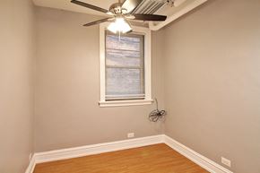 Chicago apartment for rent - a bedroom with a ceiling fan and a window
