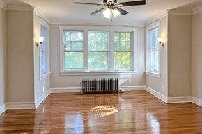 Oak Park apartment for rent - A room with a ceiling fan and a radiator on the floor.