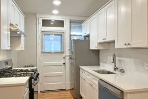Oak Park apartment for rent - A kitchen with white cabinets and a black stove top.