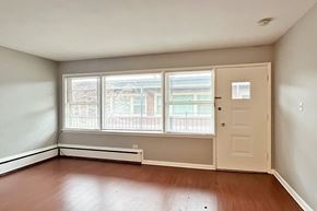 Oak Park apartment for rent - A room with a door, window, and radiator.