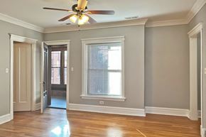 Oak Park apartment for rent - A room with a ceiling fan and a window.