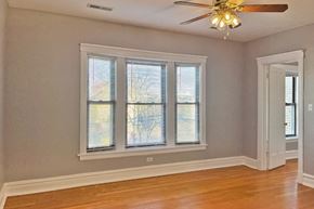 Oak Park apartment for rent - A room with a ceiling fan and a window with blinds.
