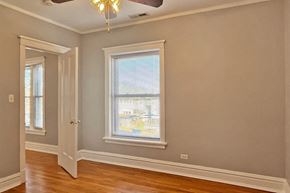 Oak Park apartment for rent - A room with a ceiling fan and a window with blinds.