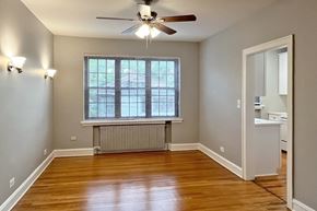 Oak Park apartment for rent - A room with a ceiling fan and a window with blinds.