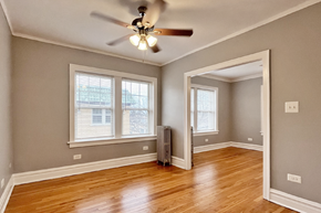 Oak Park apartment for rent - A room with a ceiling fan and two windows.