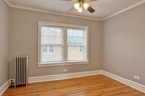 Oak Park apartment for rent - A room with a window and a ceiling fan.