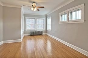 Oak Park apartment for rent - A room with a ceiling fan and wooden flooring.