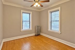 Oak Park apartment for rent - A room with a ceiling fan and two windows.