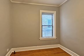 Oak Park apartment for rent - A room with a window and wooden floors.