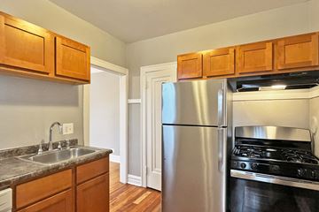 Oak Park apartment for rent - A kitchen with a stainless steel refrigerator and oven.