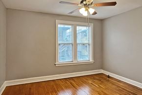Oak Park apartment for rent - A room with a ceiling fan and a window.