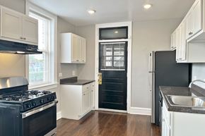 Oak Park apartment for rent - A kitchen with black appliances and white cabinets.
