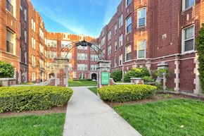 Oak Park apartment for rent - A brick building with a green sign in front.