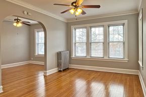 Forest Park apartment for rent - A room with a ceiling fan and a radiator on the floor.