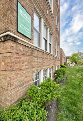 Forest Park apartment for rent - A brick building with a green sign that says Oak Park.