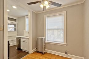 Oak Park apartment for rent - A room with a ceiling fan and a window with blinds.