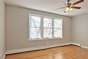 Oak Park apartment for rent - A room with a ceiling fan and a window.
