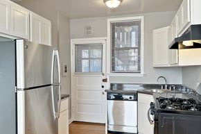 Oak Park apartment for rent - A kitchen with a stainless steel refrigerator and a stove top oven.