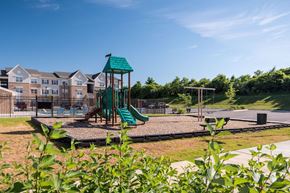 Charles Town apartment for rent - the preserve at ballantyne commons playground with play equipment and apartments in the background
