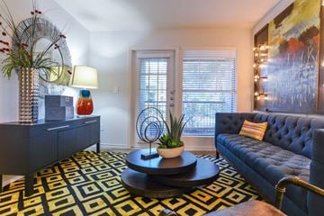 Austin apartment for rent - a living room with a blue couch and a coffee table