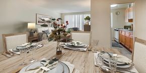 Hyattsville apartment for rent - A dining room with a wooden table set for a meal.