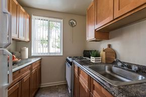 Hyattsville apartment for rent - A kitchen with wooden cabinets and a stainless steel sink.