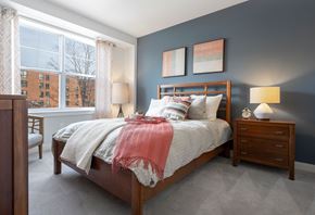 Newton apartment for rent - A bedroom with a bed, nightstand, and chair.