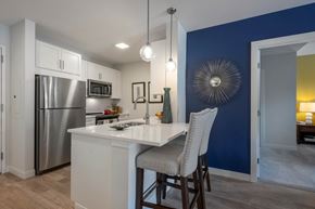 Newton apartment for rent - A kitchen with a white island and a blue wall.