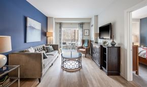 Newton apartment for rent - A living room with a couch, a chair, a coffee table, and a television.